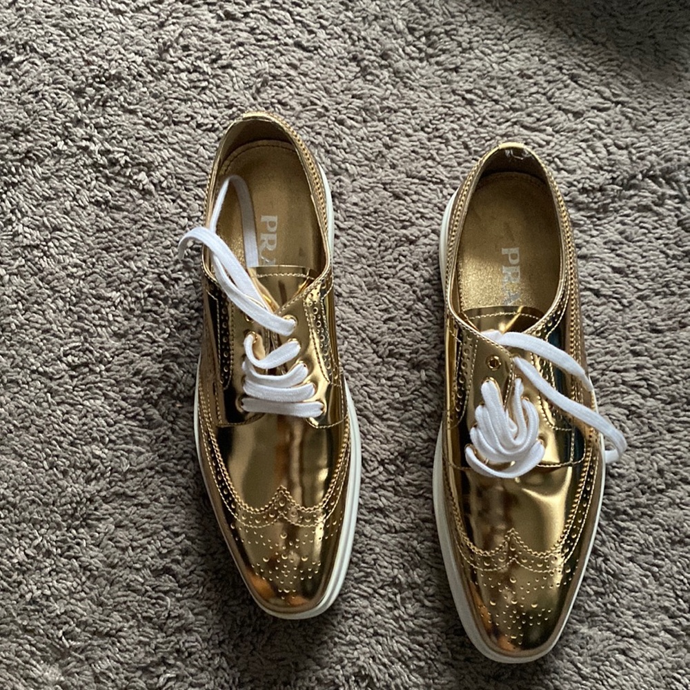 PRADA metallic gold wingtip platform oxfords